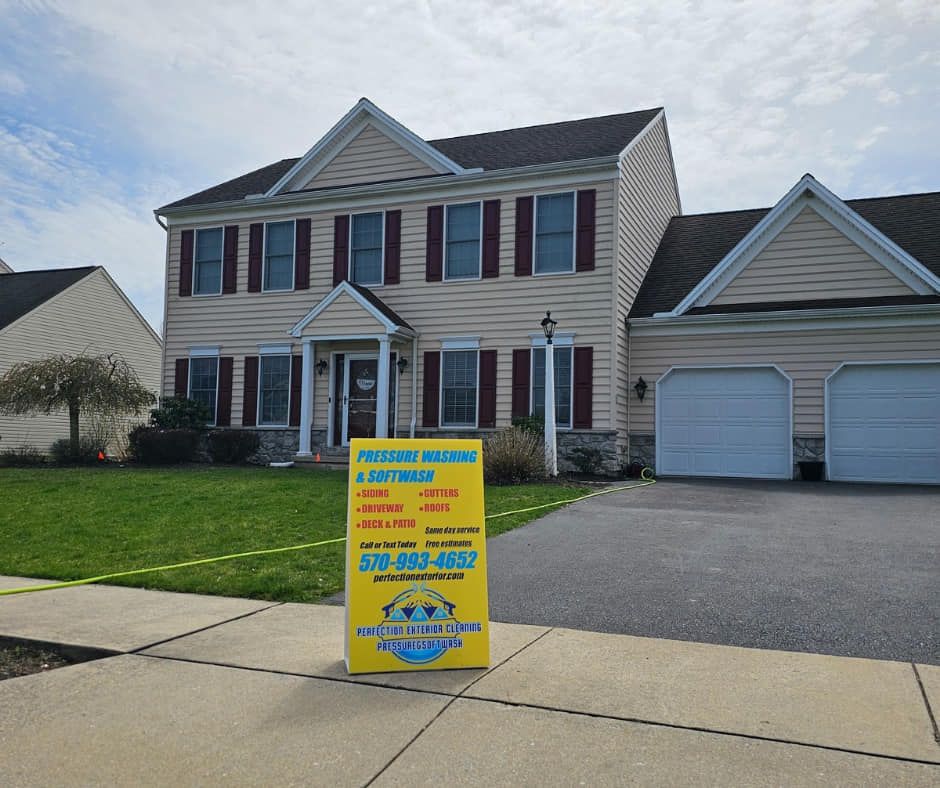 Perfection Exterior Cleaning performing soft wash roof cleaning on a Bloomsburg home.