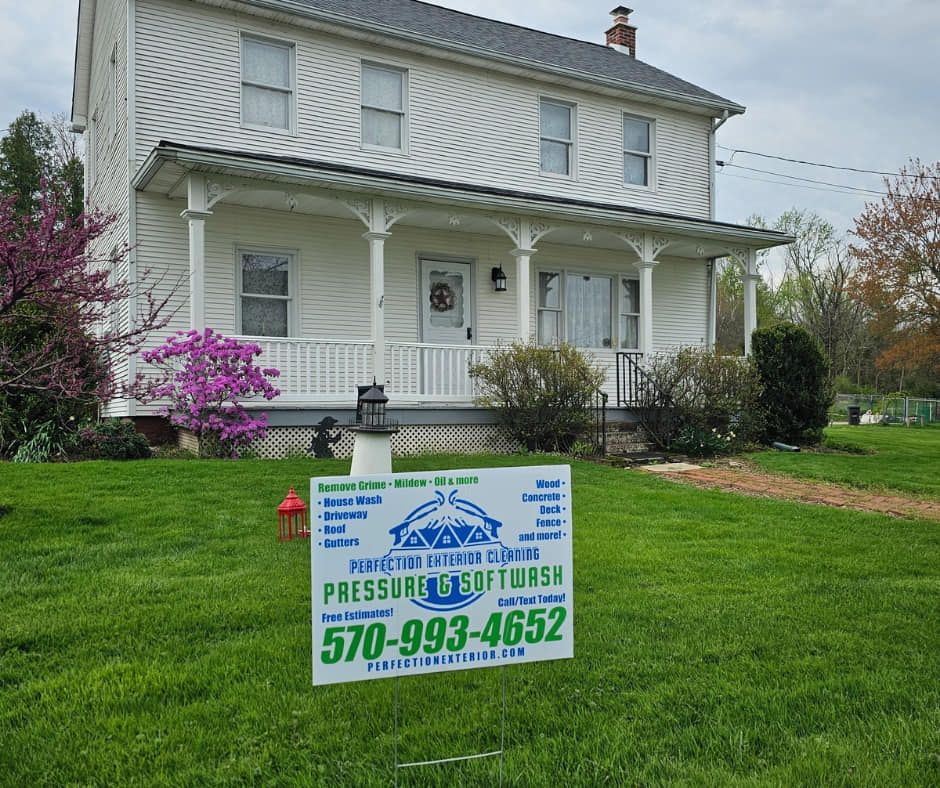 Perfection Exterior Cleaning performing soft wash roof cleaning on a Bloomsburg home.